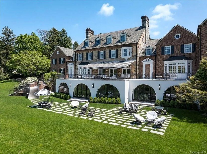 A large patio and river views are in the rear of the house.