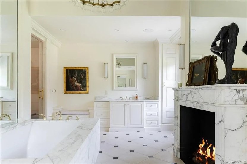 Acres of marble and another fireplace are in the main bathroom.