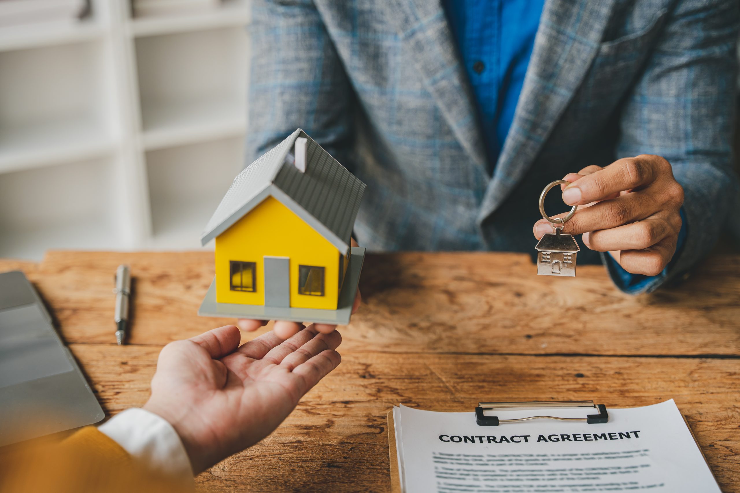 photo of a person buying a home next to a lender.
